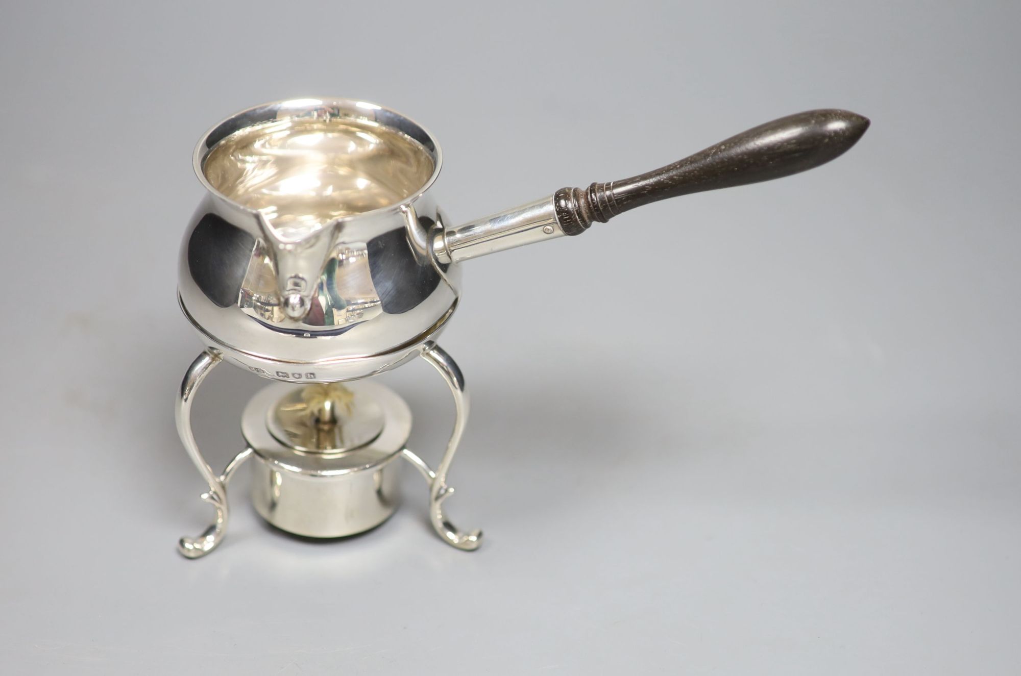 An Edwardian silver brandy warmer, on stand with burner, Henry Stratford, London, 1903, height 14.7cm, gross 9oz.